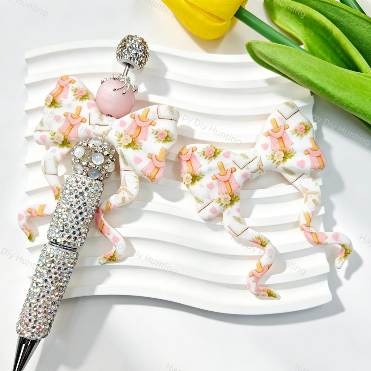 Bow-shaped silicone focal beads featuring a pink floral castle print design. Soft, durable, and flexible, perfect for beadable pens, keychains, and handmade crafts.