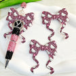 Bow-shaped silicone focal beads featuring a pink leopard and cute white cat cartoon design. Soft, durable, and flexible, perfect for beadable pens, keychains, and handmade crafts.