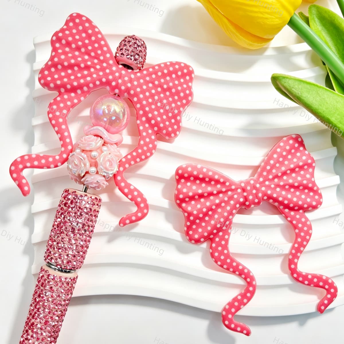 Silicone bow beads featuring a pink polka dot print design. Soft, durable, and flexible, perfect for beadable pens, keychains, and handmade crafts.