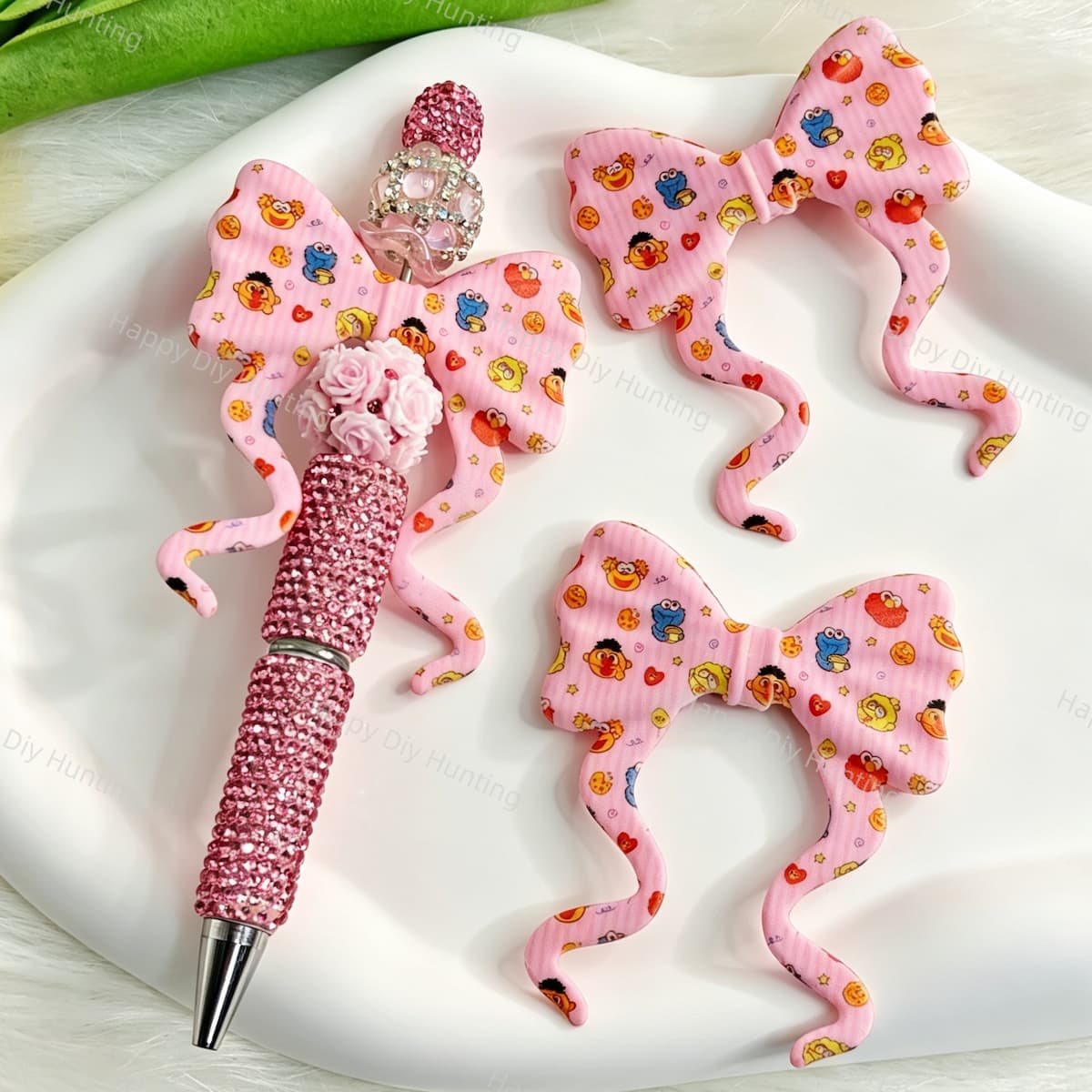 Bow-shaped silicone focal beads featuring a pink striped cute cartoon monster design. Soft, durable, and flexible, perfect for beadable pens, keychains, and handmade crafts.
