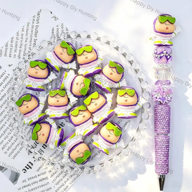 Mini space figure pen toppers with purple white suit and green goggles for handmade bead pens
