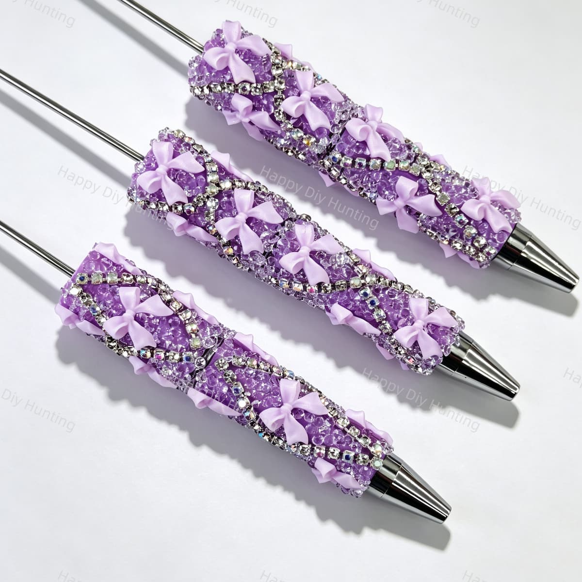 Purple beadable pen featuring a decorative bow and sparkling rhinestones. Refillable and customizable, perfect for DIY crafts and handmade gifts.
