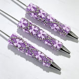 Purple beadable pen featuring a decorative bow and sparkling rhinestones. Refillable and customizable, perfect for DIY crafts and handmade gifts.