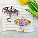 Purple flying winged dragon metal fancy bead with rhinestones shown from the front and back. The front features a detailed purple dragon with enamel wings and a rhinestone-studded body, while the back shows gold metal wings with a purple crystal flower center. Perfect for DIY beadable pens and crafts.