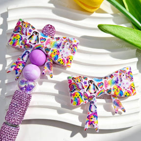 Bow-shaped silicone focal beads featuring a rainbow cute animal print design. Soft, durable, and flexible, perfect for beadable pens, keychains, and handmade crafts.