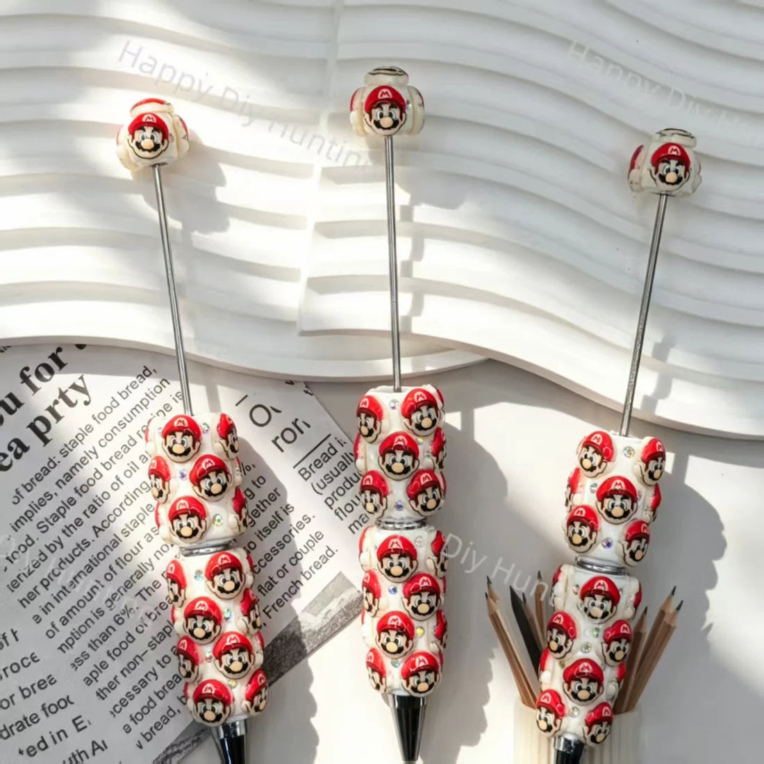 pre‑assembled red‑cap plumber‑style 3D character figurine beadable pens with embedded sparkling rhinestones bulk fun themed craft ballpoint pens