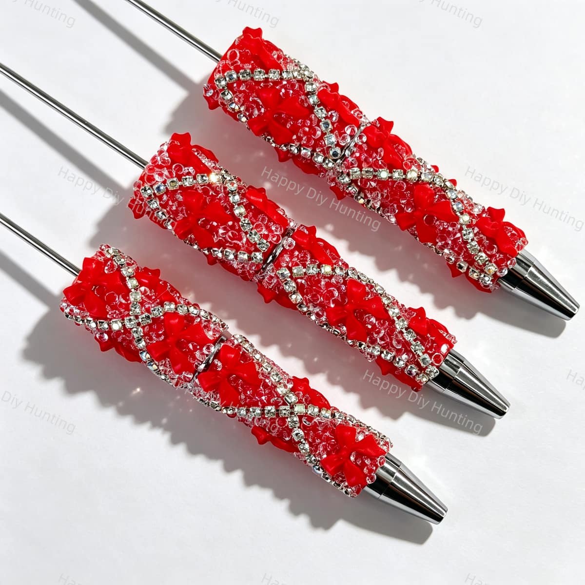 Red beadable pen featuring a decorative bow and sparkling rhinestones. Refillable and customizable, perfect for DIY crafts and handmade gifts.