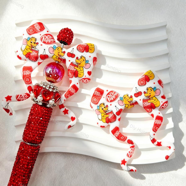 Bow-shaped silicone focal beads featuring a red cartoon mouse and soda print design. Soft, durable, and flexible, perfect for beadable pens, keychains, and handmade crafts.