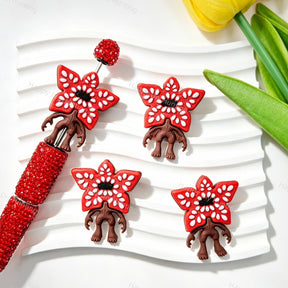 Silicone focal beads featuring a red flower monster character design. Soft, durable, and flexible, perfect for beadable pens, keychains, and handmade crafts.