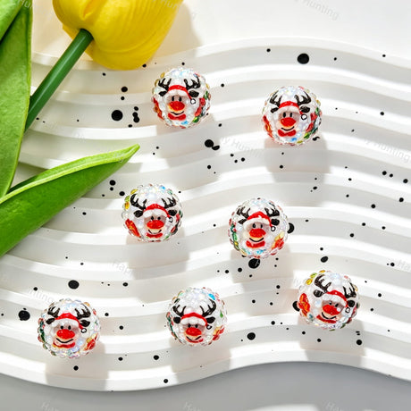 Clear acrylic beads featuring a red nose reindeer wearing a Santa hat, with black antlers, a red scarf, and colorful candy dots on a faceted rhinestone surface. Perfect for DIY beadable pens, keychains, and handmade holiday crafts.