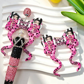 Bow-shaped silicone focal beads featuring a retro pink leopard lady character print design. Soft, durable, and flexible, perfect for beadable pens, keychains, and handmade crafts.