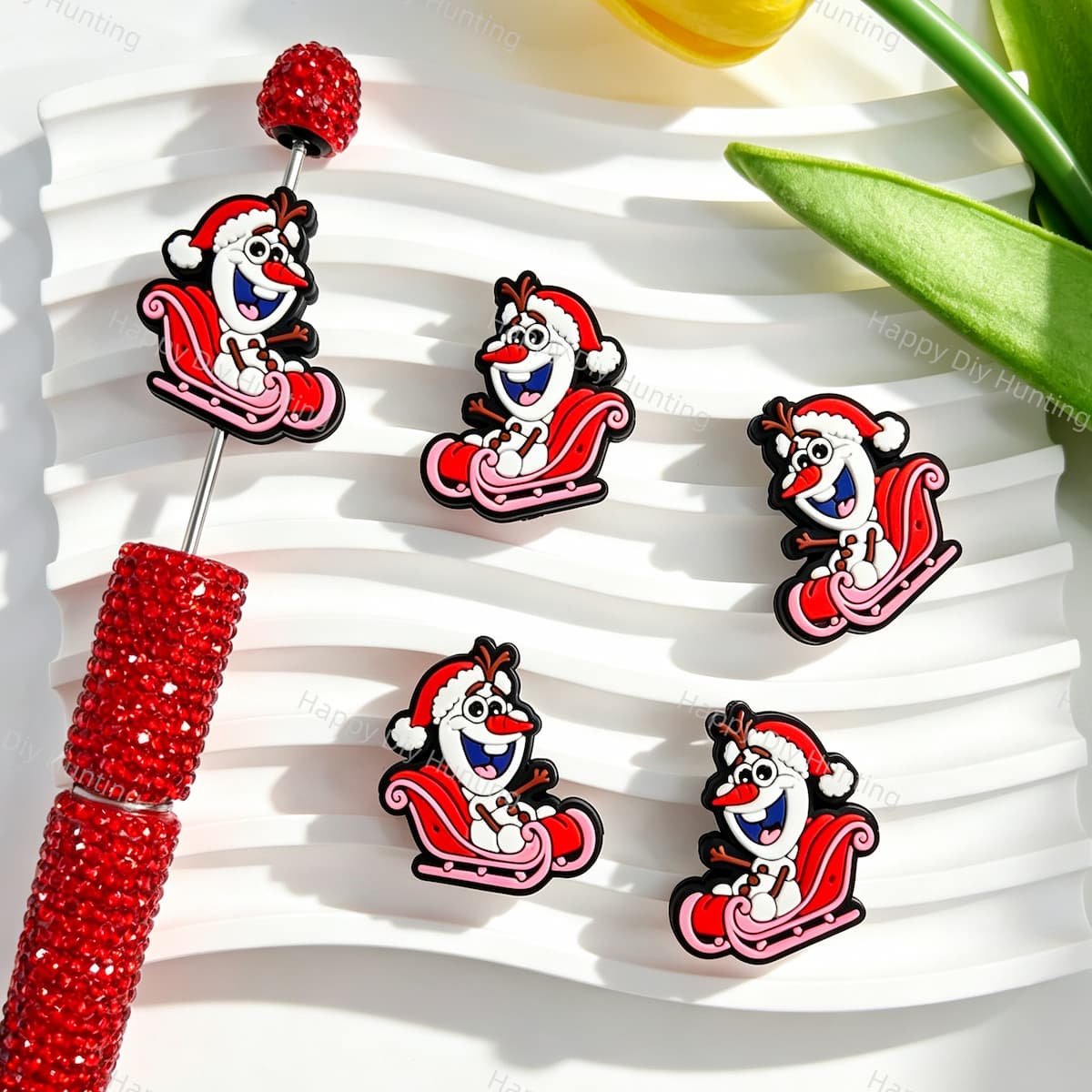 Silicone focal beads featuring a snowman with a Santa hat riding a sleigh print design. Soft, durable, and flexible, perfect for beadable pens, keychains, and handmade holiday crafts.