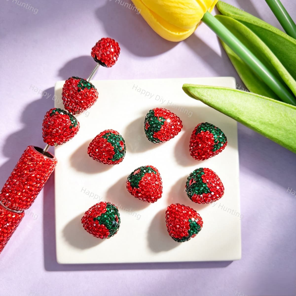 Strawberry rhinestone beads measuring approximately 16mm by 18mm. Shiny, durable, and eye-catching, perfect for beadable pens, keychains, and handmade crafts.