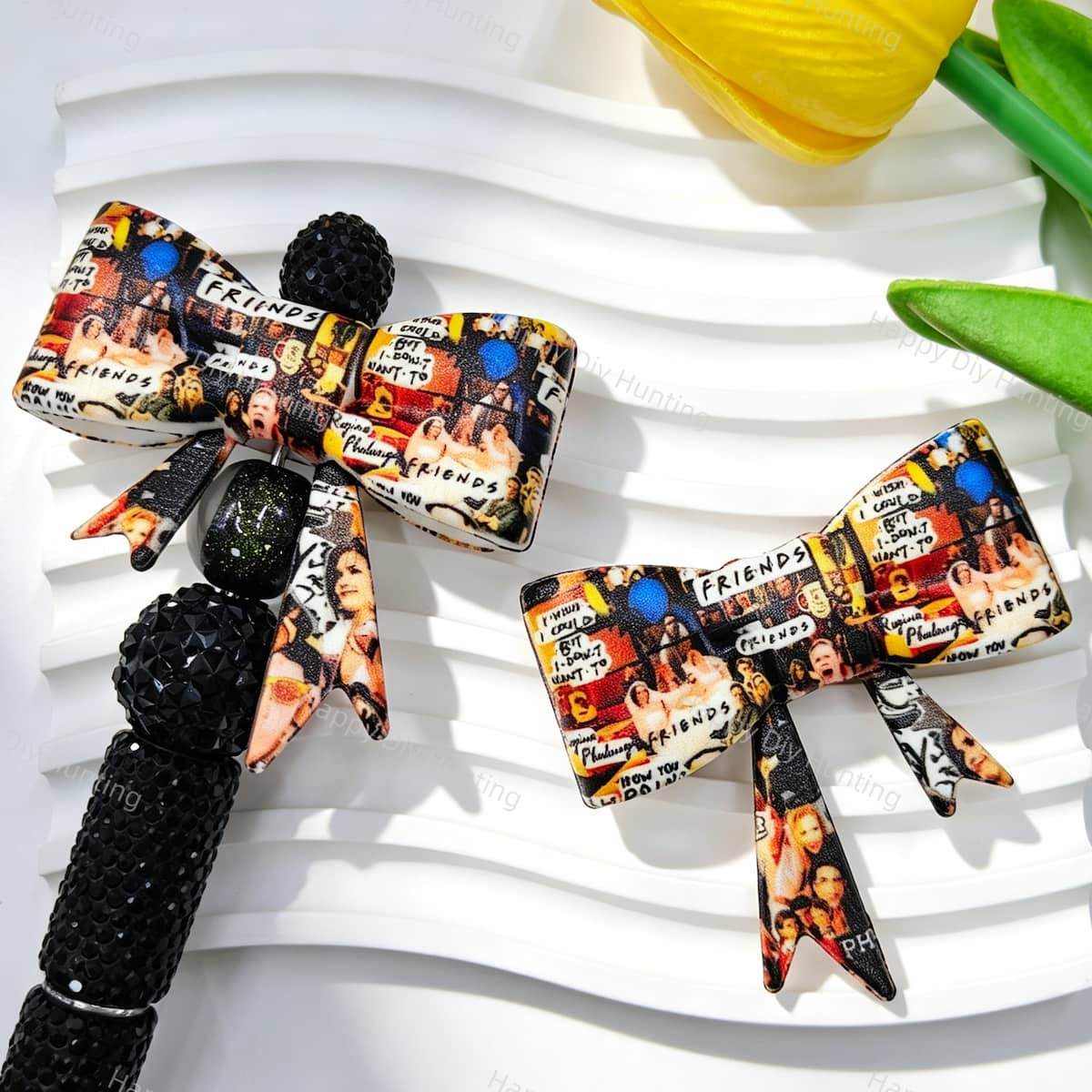 Bow-shaped silicone focal beads featuring a TV show scene collage print design. Soft, durable, and flexible, perfect for beadable pens, keychains, and handmade crafts.