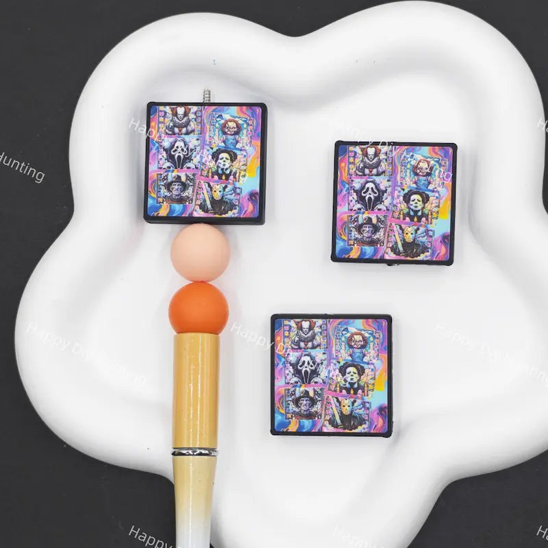 Psychedelic tie-dye gradient square silicone focal beads featuring a collage of classic horror movie villains, for Halloween beadable pens, keychains, goth handmade craft accessories.