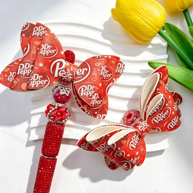 Bow-shaped focal beads featuring a vintage deep red soda pop print design. Sturdy, colorful, and easy to customize, perfect for beadable pens, keychains, and handmade crafts.