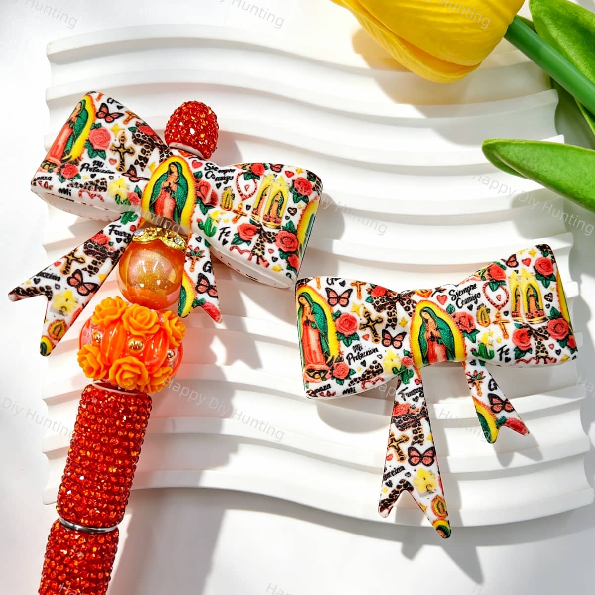 Bow-shaped silicone focal beads featuring a vintage tattoo style religious figure, red roses, cactus, and decorative elements on a white background. Soft, durable, and flexible, perfect for beadable pens, keychains, and handmade crafts.