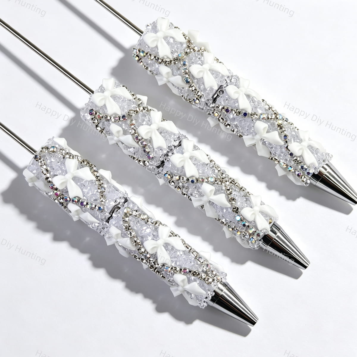 White beadable pen featuring a decorative bow and sparkling rhinestones. Refillable and customizable, perfect for DIY crafts and handmade gifts.