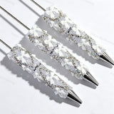 White beadable pen featuring a decorative bow and sparkling rhinestones. Refillable and customizable, perfect for DIY crafts and handmade gifts.