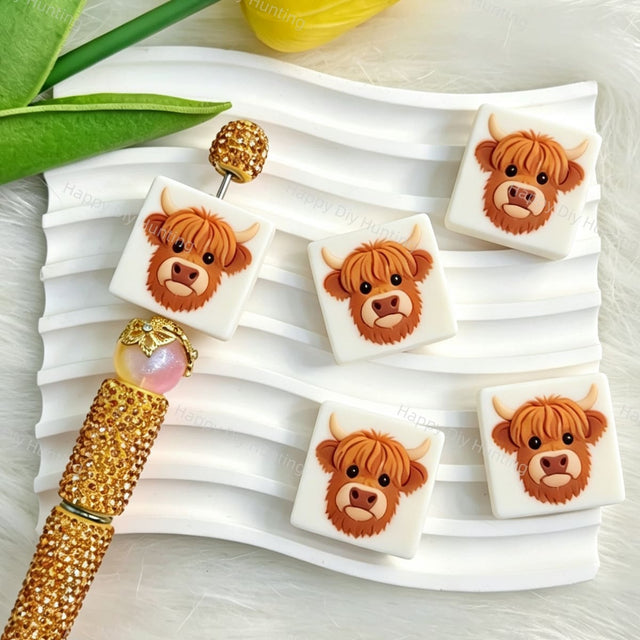 White square-shaped silicone focal beads featuring a cute cartoon highland cow design. Soft, durable, and flexible, perfect for beadable pens, keychains, and handmade crafts.