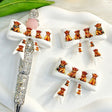 Bow-shaped silicone focal beads featuring a white cute highland cow cartoon design. Soft, durable, and flexible, perfect for beadable pens, keychains, and handmade crafts