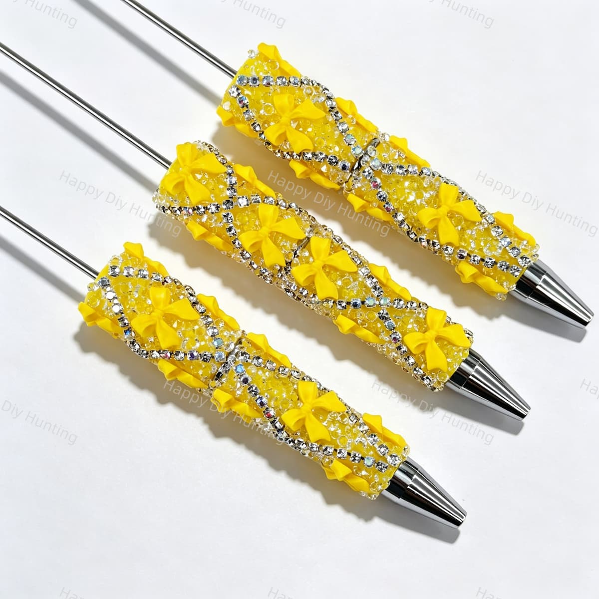 Yellow beadable pen featuring a decorative bow and sparkling rhinestones. Refillable and customizable, perfect for DIY crafts and handmade gifts.