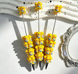 	Three yellow haired cartoon girl character beadable pens displayed on a white wavy tray. Each pen features yellow beads decorated with cartoon girl faces wearing blue dresses and clear rhinestones, paired with silver metal tips. Perfect for DIY beadable pen projects, focal beads, and pen toppers.