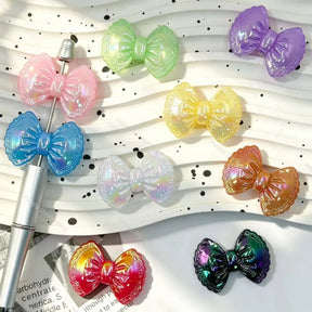 Aurora bow shaped acrylic focal beads for beadable pens and handmade jewelry making. Iridescent lace detail bow beads for diy craft projects, free US shipping over $50.
