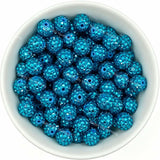 Cyan rhinestone beads in matte white bowl, white background, top‑down view, high‑resolution product photo