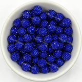 Dark blue rhinestone beads in matte white bowl, white background, top‑down view, high‑resolution product photo