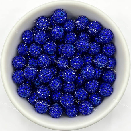 Dark blue rhinestone beads in matte white bowl, white background, top‑down view, high‑resolution product photo