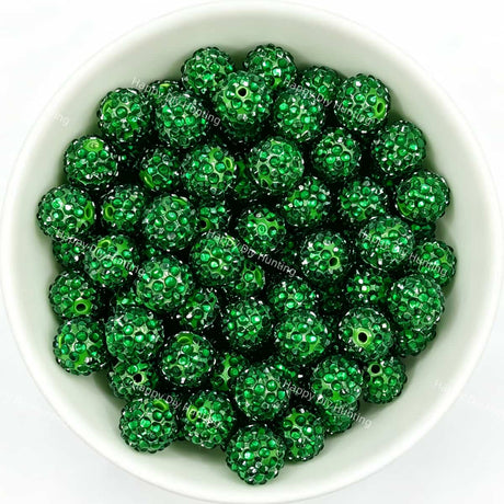 Dark green rhinestone beads in matte white bowl, white background, top‑down view, high‑resolution product photo