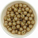 Gold rhinestone beads in matte white bowl, white background, top‑down view, high‑resolution product photo
