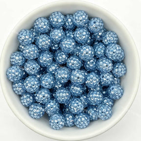 Light blue rhinestone beads in matte white bowl, white background, top‑down view, high‑resolution product photo