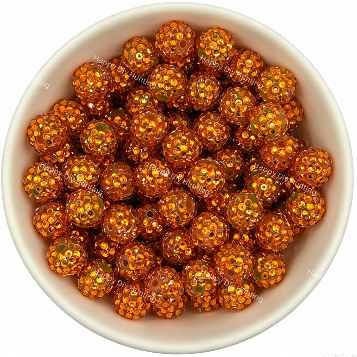 Orange rhinestone beads in matte white bowl, white background, top‑down view, high‑resolution product photo