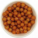 Orange rhinestone beads in matte white bowl, white background, top‑down view, high‑resolution product photo