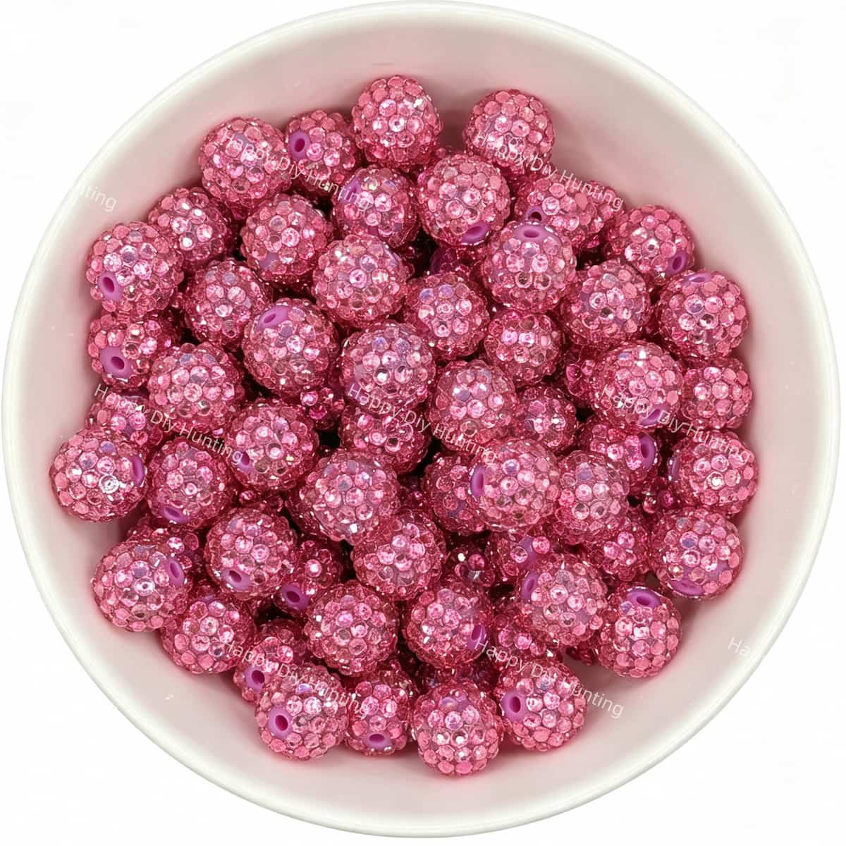 Pink rhinestone beads in matte white bowl, white background, top‑down view, high‑resolution product photo