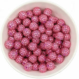 Pink rhinestone beads in matte white bowl, white background, top‑down view, high‑resolution product photo