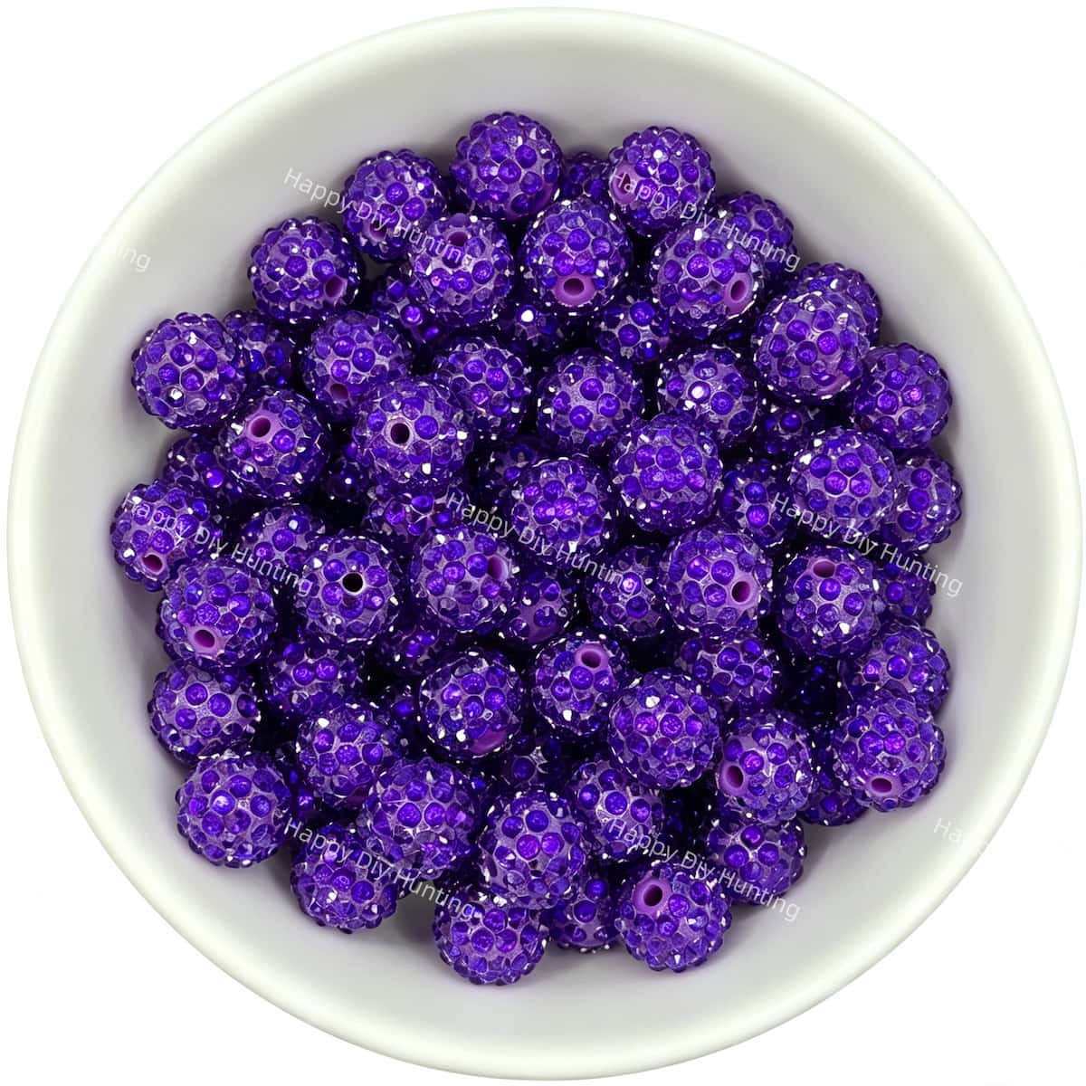 Purple rhinestone beads in matte white bowl, white background, top‑down view, high‑resolution product photo