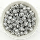 Silver rhinestone beads in matte white bowl, white background, top‑down view, high‑resolution product photo