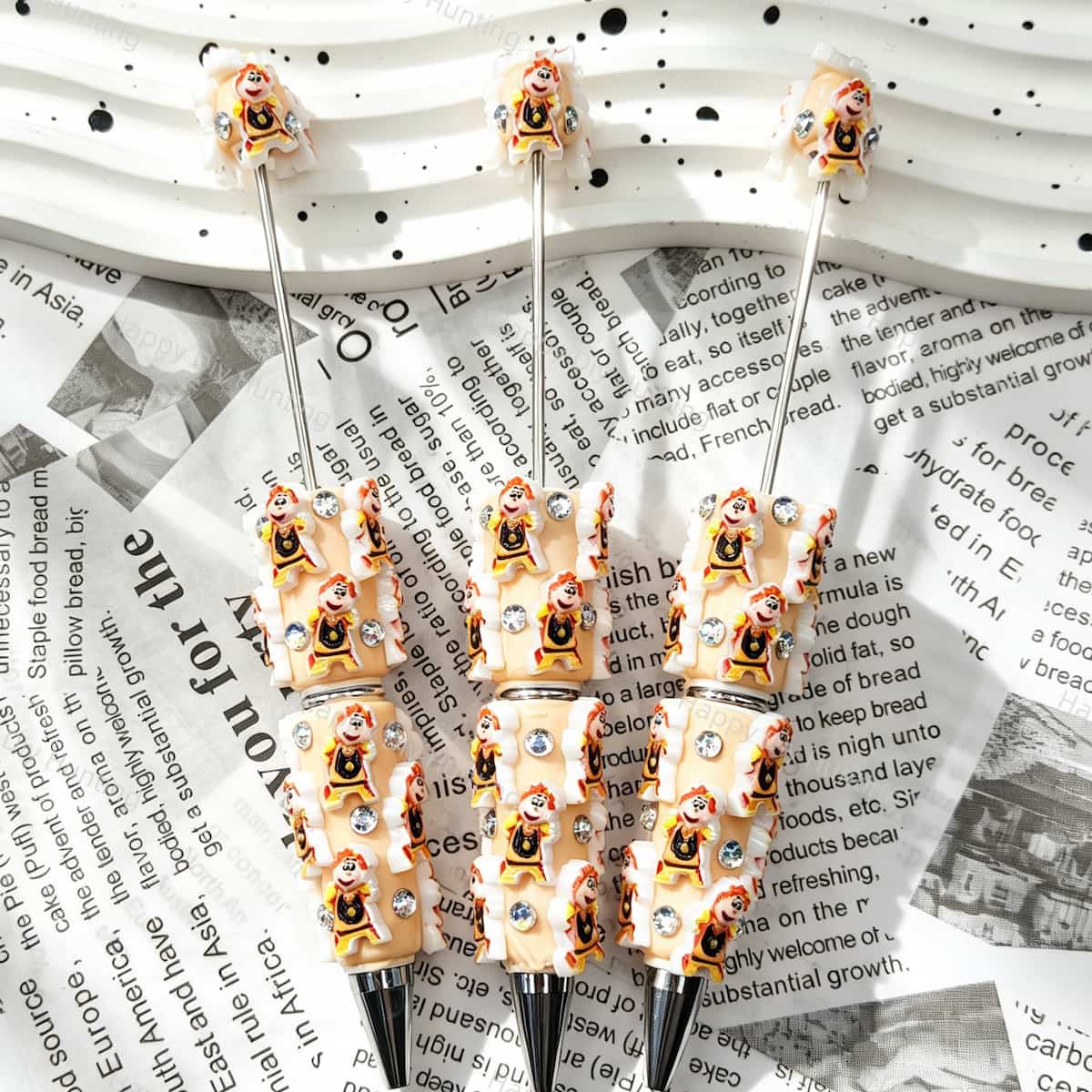 Beige little boy relief beadable pens, raised cartoon boy motifs with white trim and multi‑color rhinestones, diy craft pen blanks