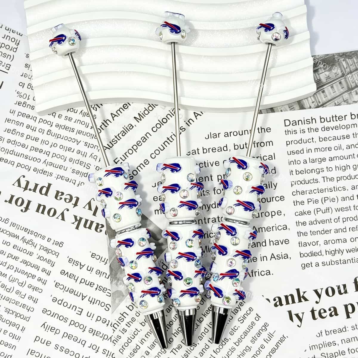 close-up blue-red running bison BB football beadable pen showing bison design and beadable barrel