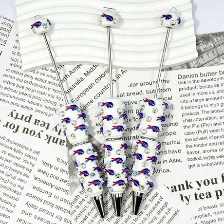close-up blue-red running bison BB football beadable pen showing bison design and beadable barrel