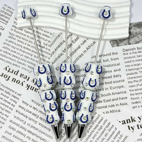 close-up blue-white horseshoe IC football print bow bead showing team spirit design