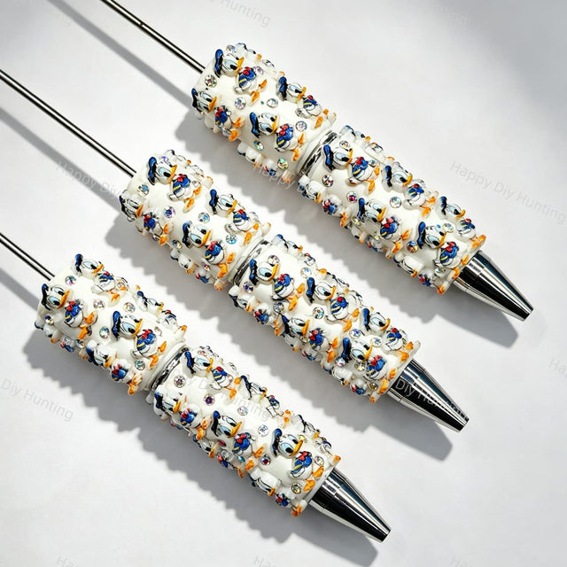 Blue‑yellow duck cartoon character beadable pens, white printed pen bases with rhinestone accents for DIY custom pen craft projects