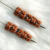 close-up brown Richard beadable pen showing colorful Richard design and beadable barrel