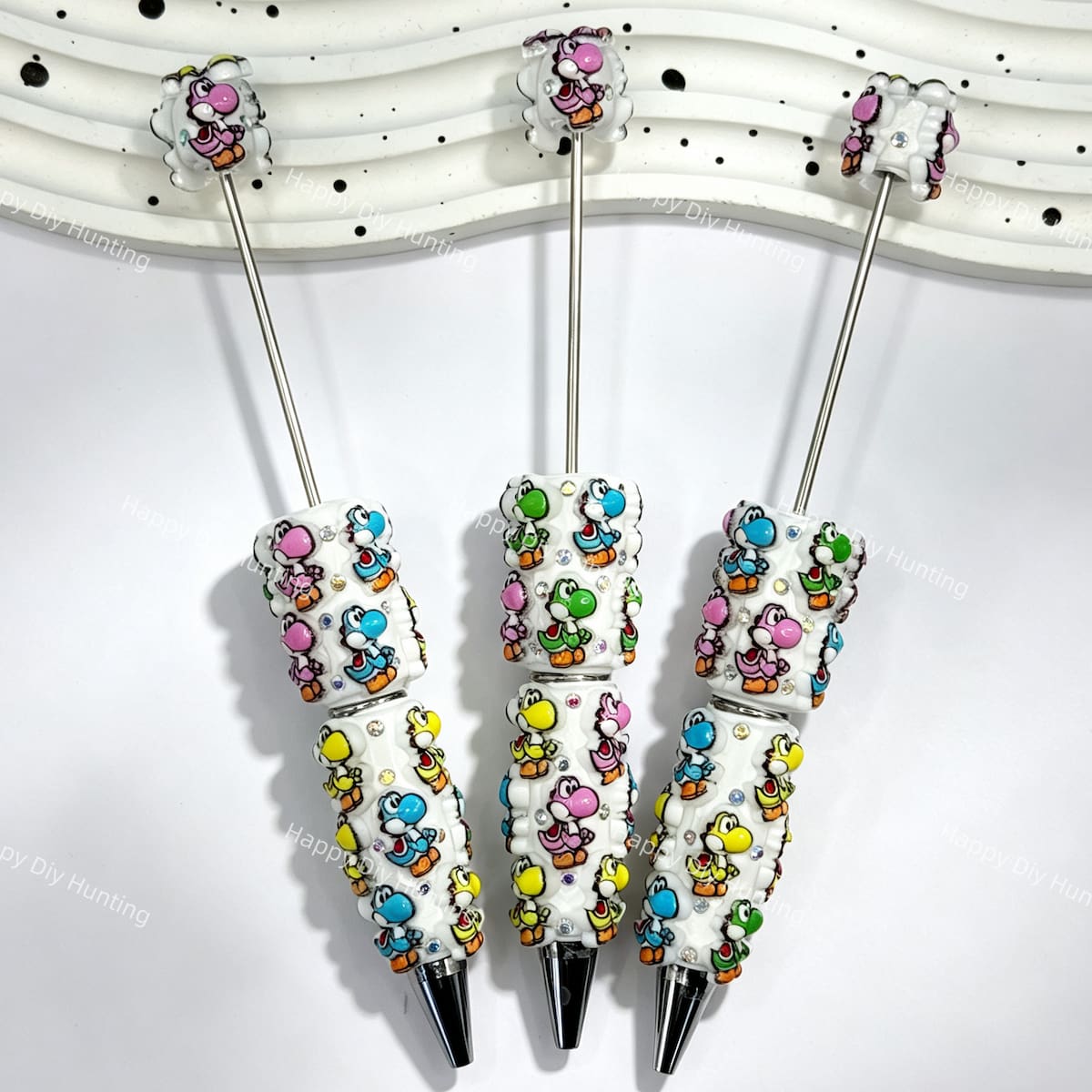 close-up colorful dinosaur beadable pen showing dinosaur design and beadable barrel