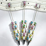 close-up colorful dinosaur beadable pen showing dinosaur design and beadable barrel
