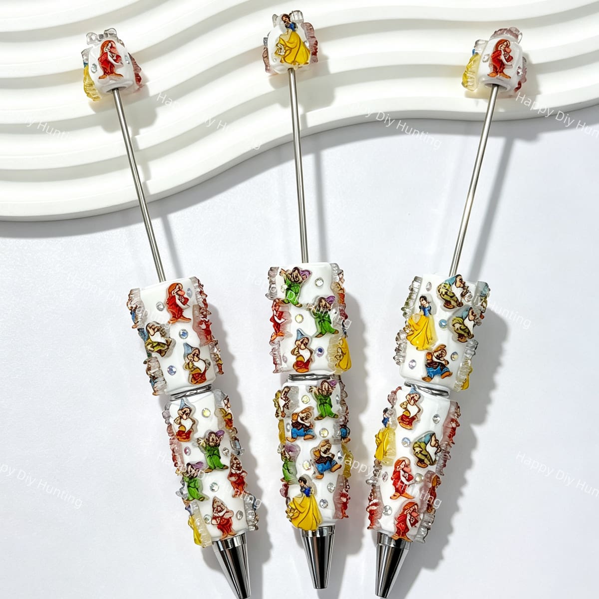 close-up fairytale maiden and seven little friends beadable pen showing storybook character designs