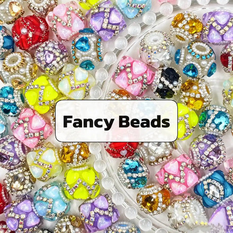 Assorted fancy decorative beads with rhinestone and pearl embellishments.
